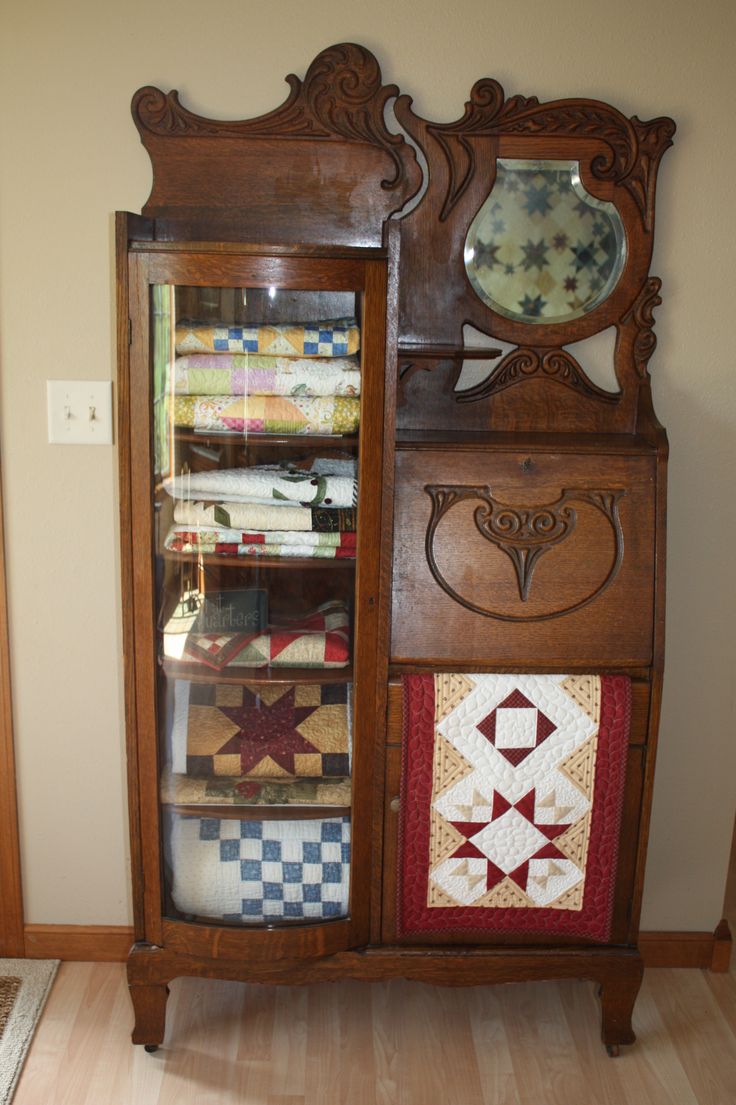 an antique china cabinet with quilts on the front and side panels, is featured in this facebook post