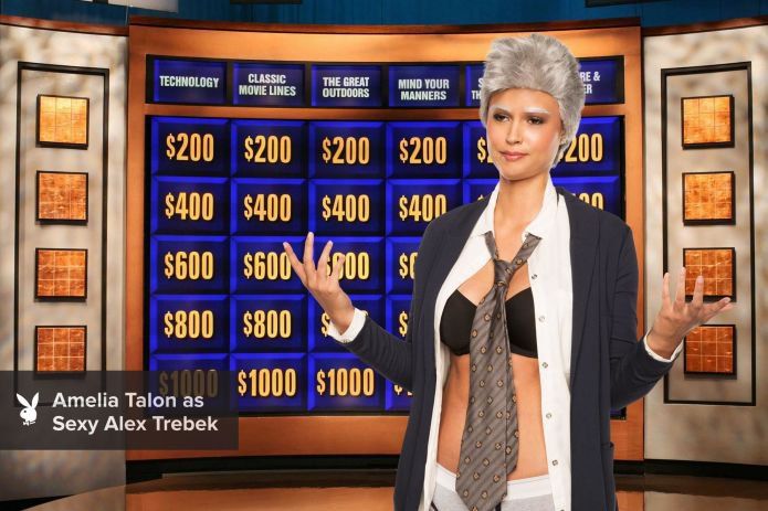 a woman standing in front of a tv screen with money signs on the wall behind her