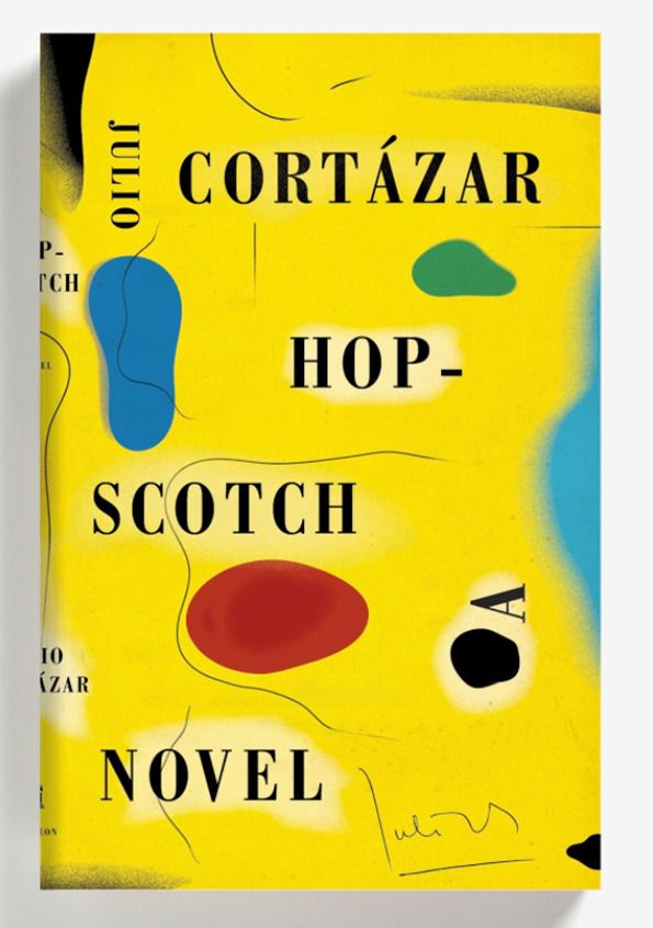 a yellow book cover with black, red and blue shapes on it's front