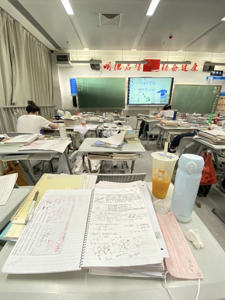 an empty classroom with desks and computers