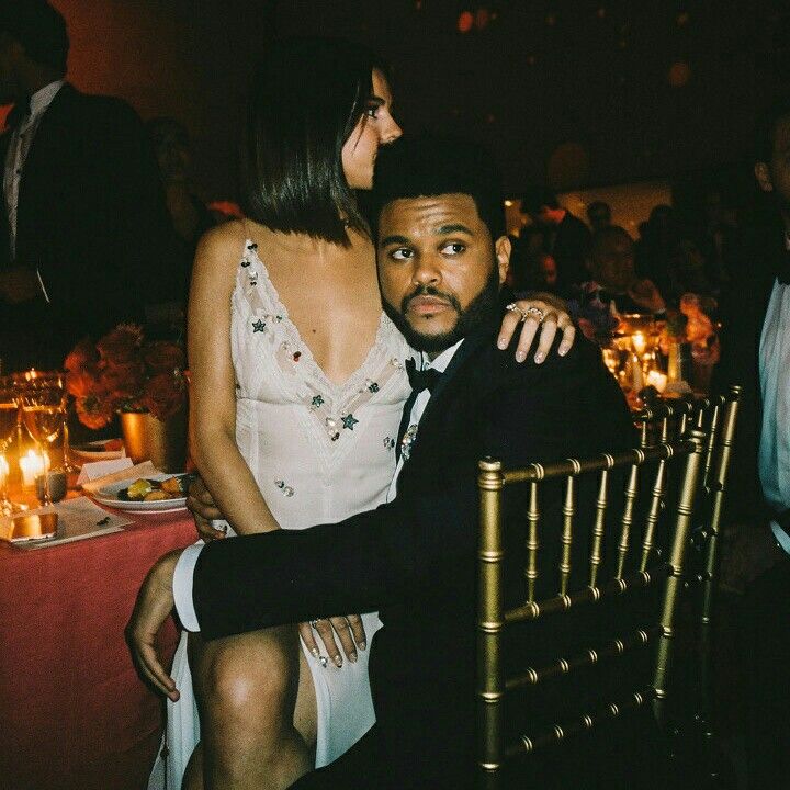 a man and woman sitting next to each other at a dinner table