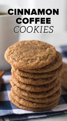 a stack of cinnamon coffee cookies next to a cup of coffee on a checkered table cloth