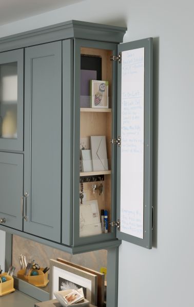 a kitchen with gray cabinets and white walls