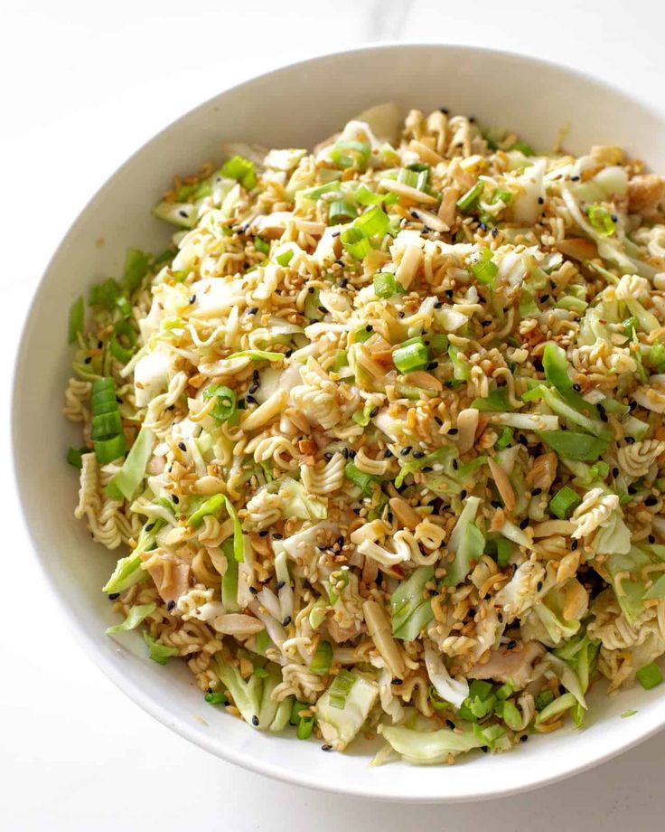 a white bowl filled with rice and vegetables