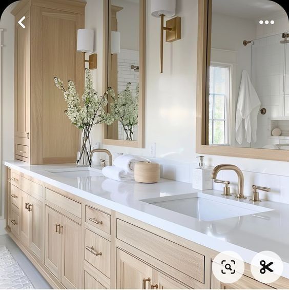 a large bathroom with two sinks and mirrors on the wall above them is shown in this image