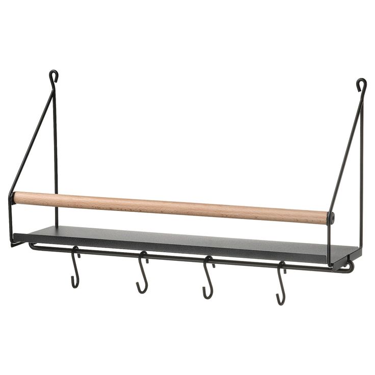 a metal shelf with two hooks and a wooden stick hanging from the wall above it