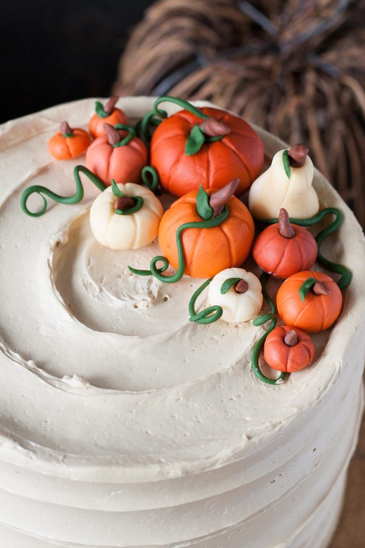 a cake with white frosting and pumpkins on top