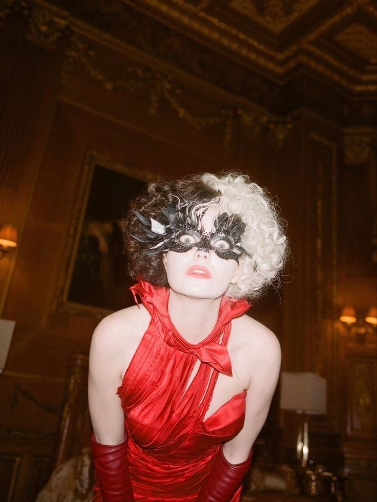 a woman in a red dress and blindfold