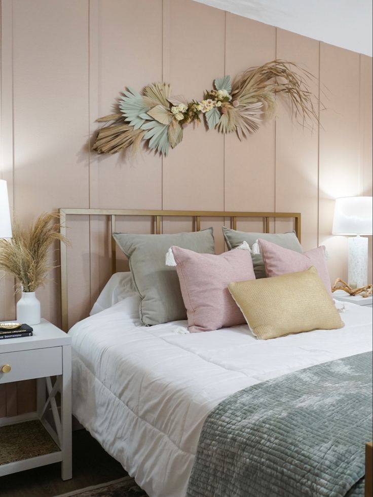 a bedroom with pink walls and white bedding