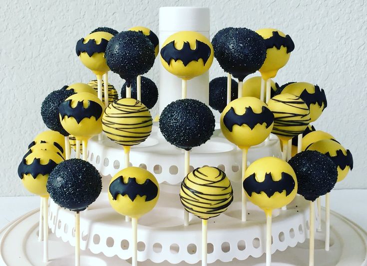 cake pops decorated with black and yellow batman decorations