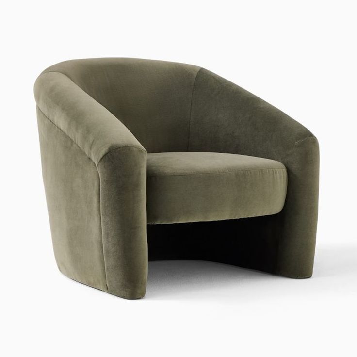 the curved chair is made out of green velvet