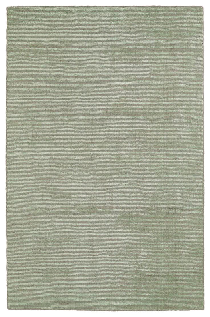 an area rug with light green colors