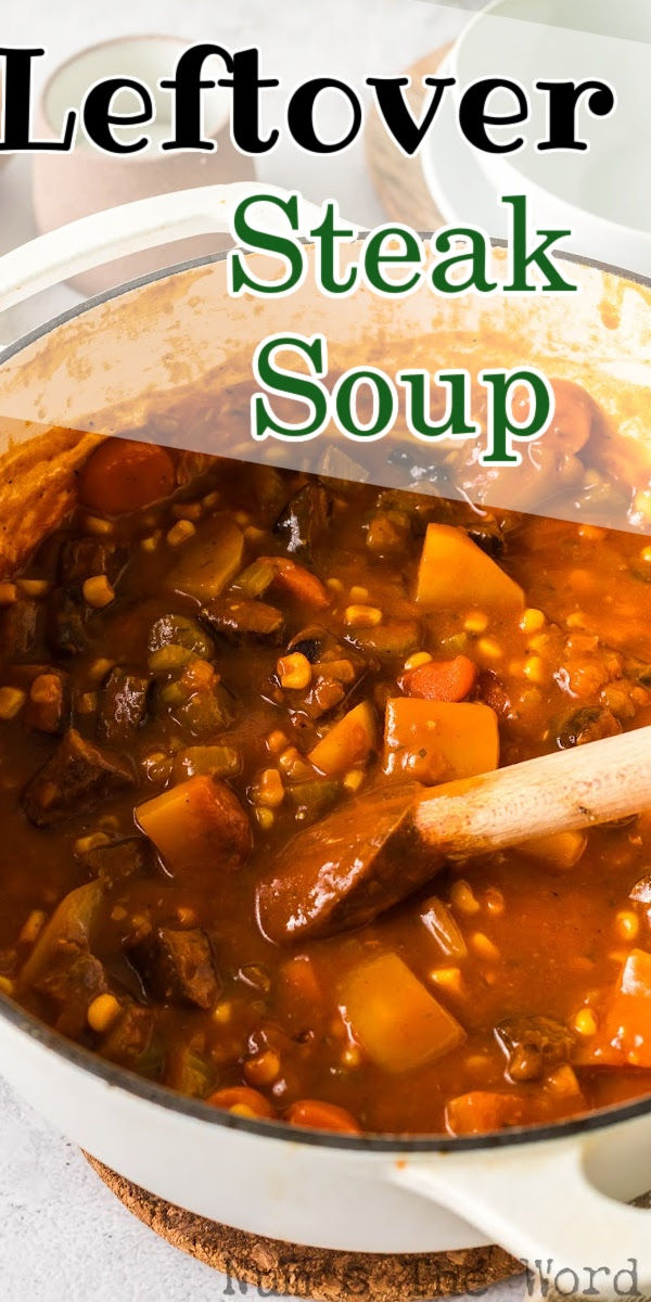 a white pot filled with stew next to a wooden spoon on top of a table