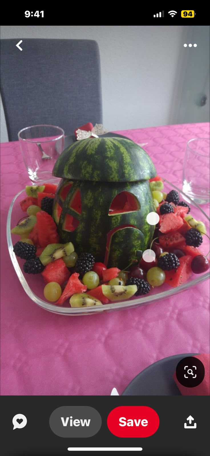 a watermelon house made out of fruit on a plate