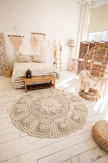 a room with wicker furniture and rugs on the floor