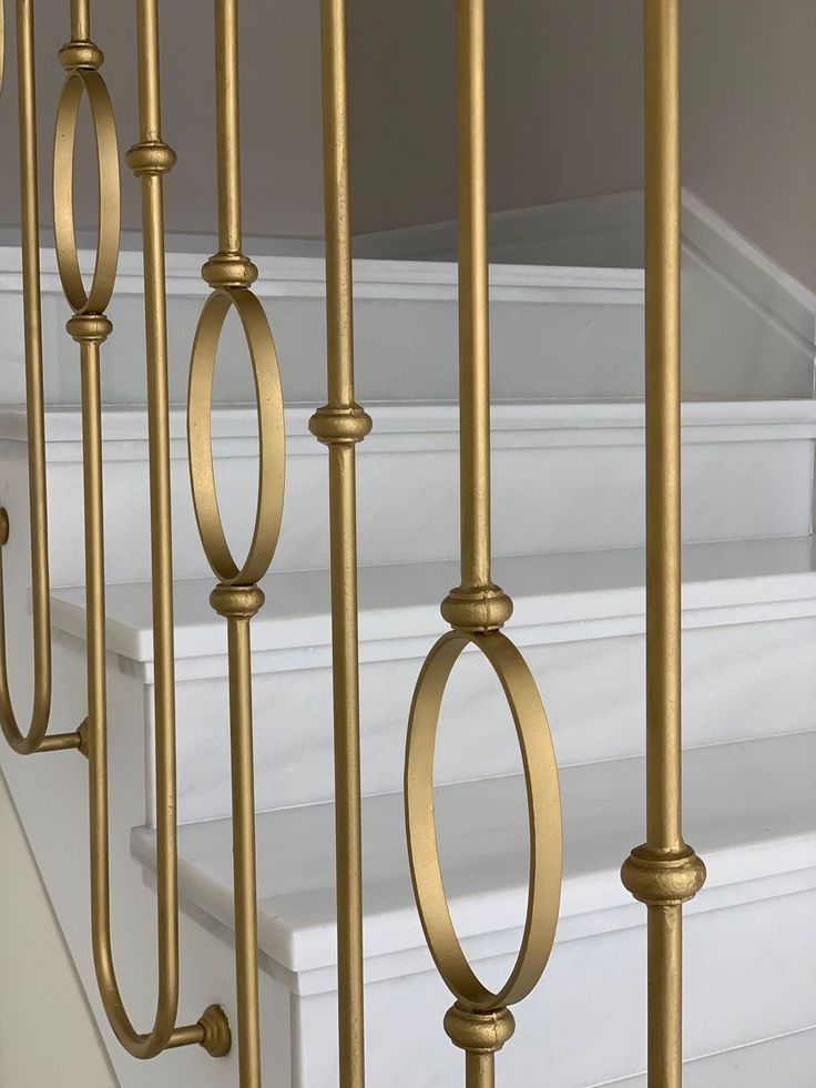 an image of a set of stairs with railings and handrails in gold