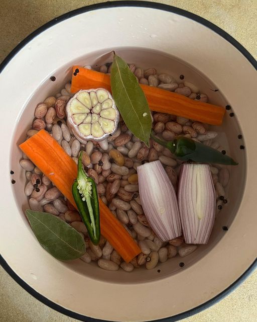 a bowl filled with beans, carrots and other vegetables