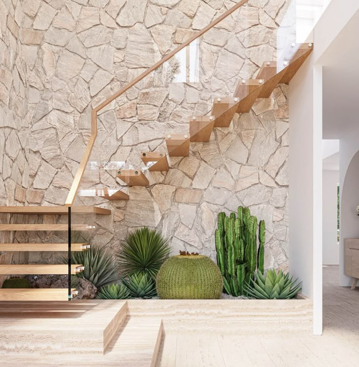 the interior of a house with stone walls and wooden steps leading up to an indoor stair case