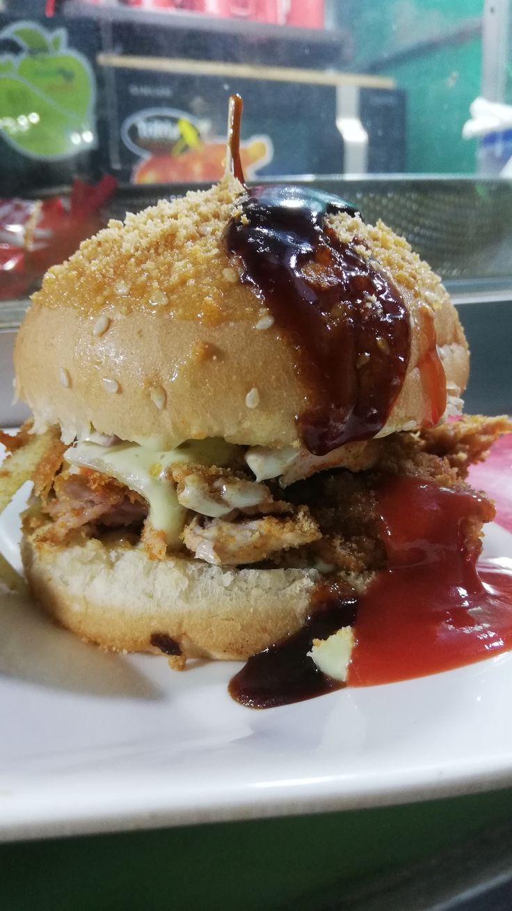 a close up of a sandwich on a plate with ketchup