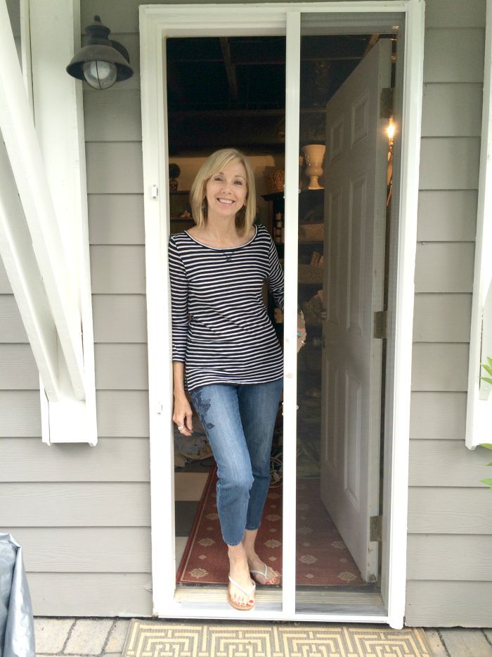 a woman standing in the doorway of a house