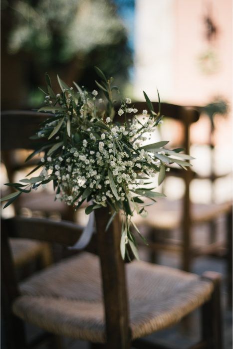 a bouquet of flowers sitting on top of a wooden chair