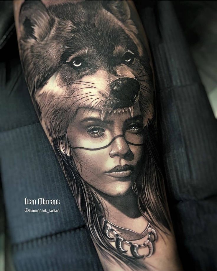 a woman with glasses and a wolf tattoo on her arm is featured in this photo