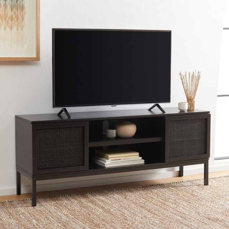 a flat screen tv sitting on top of a wooden entertainment center