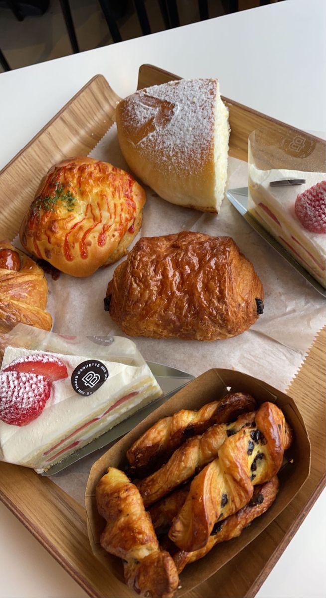 there are many different types of pastries on the tray