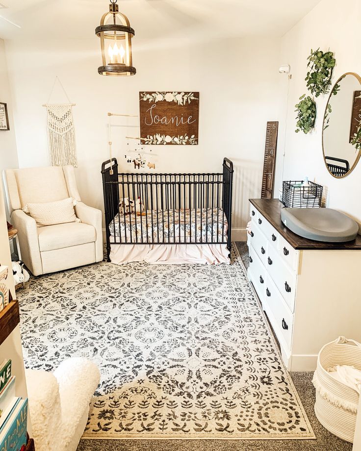 a baby's room with a crib, dresser and chair