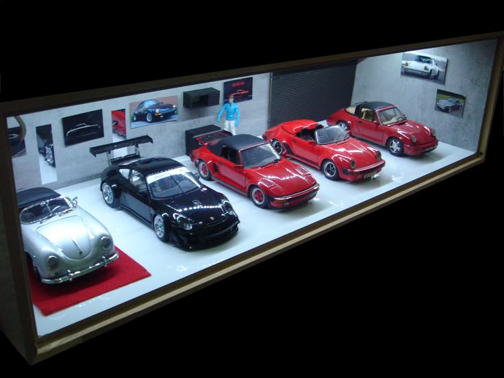 a display case filled with lots of different types of cars on top of a table