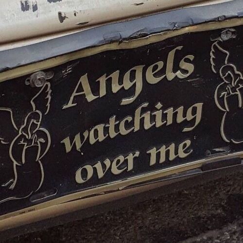 an old sign that says angels watching over me on the side of a car door