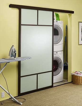 an ironing board in the corner of a room next to a washer and dryer