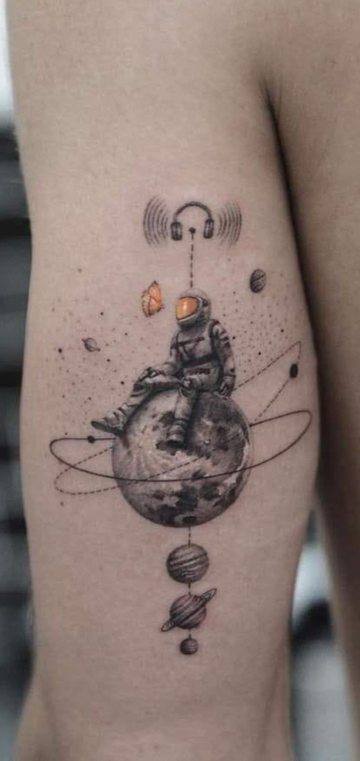 a tattoo on the back of a woman's thigh shows an image of saturn and its satellites