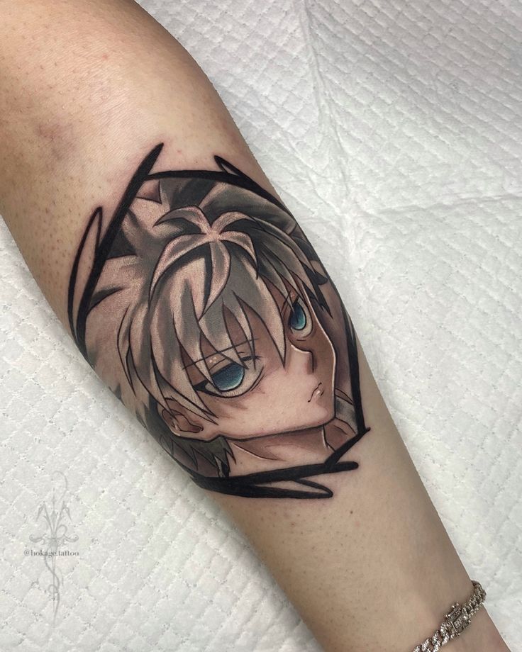 a woman's arm with an anime character tattoo on it