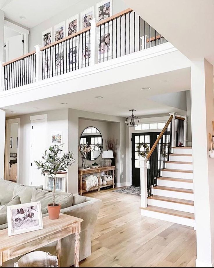 a living room filled with furniture and a staircase