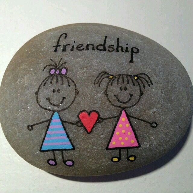 two children holding hands on a rock with the words,'friends'painted on it