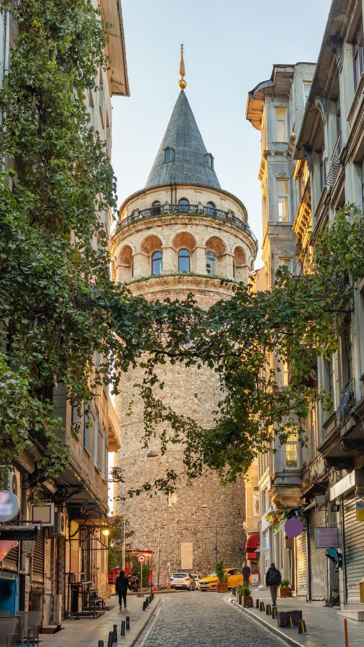 an old stone building with a dome on top in the middle of a city street