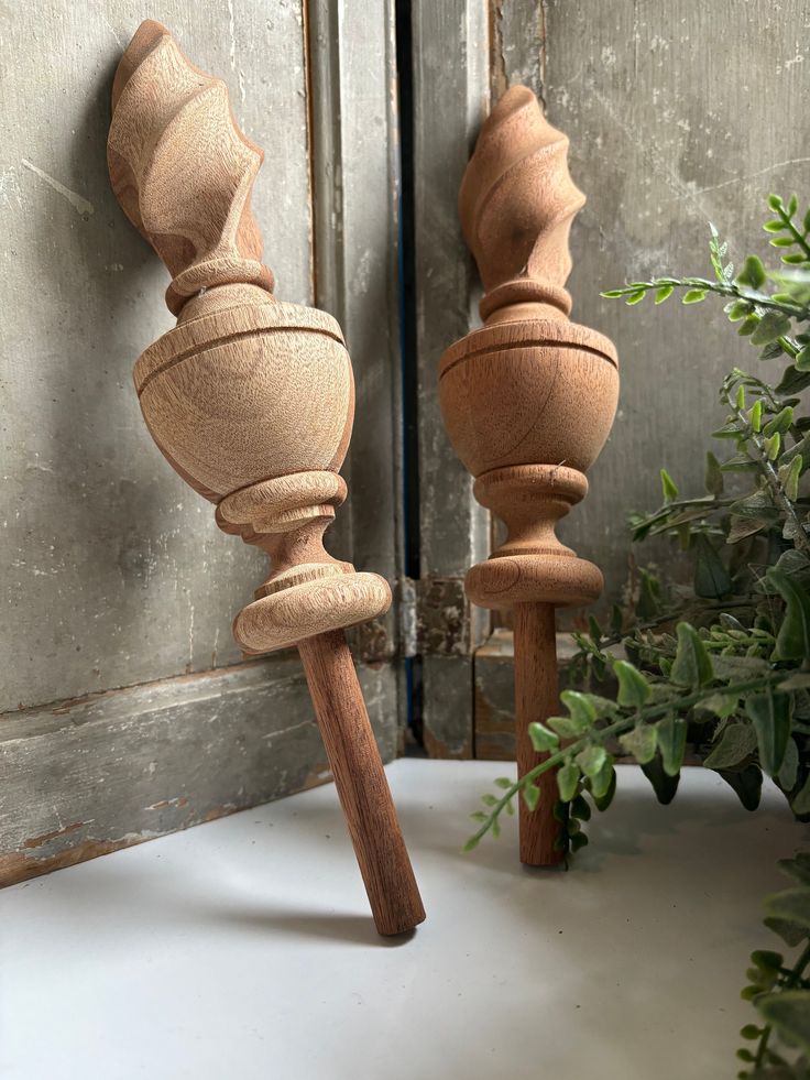 two wooden candlesticks sitting next to each other