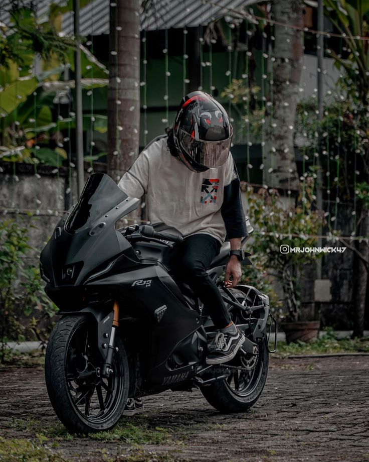 a man riding on the back of a black motorcycle