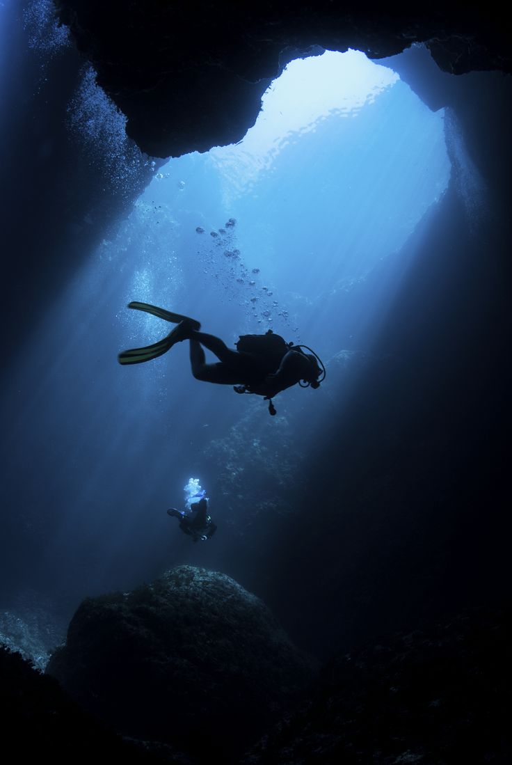 a person swimming in the ocean with a quote about diving