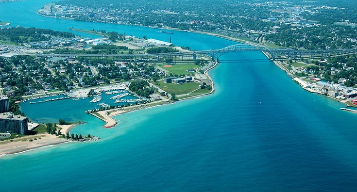 an aerial view of a city and the ocean with a bridge in the middle is shown