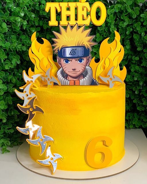 a yellow birthday cake with an anime character on top