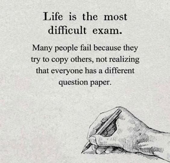 a hand holding a pen writing on paper with the words life is the most difficult exam many people fail because they try to copy others, not realizing that everyone has a