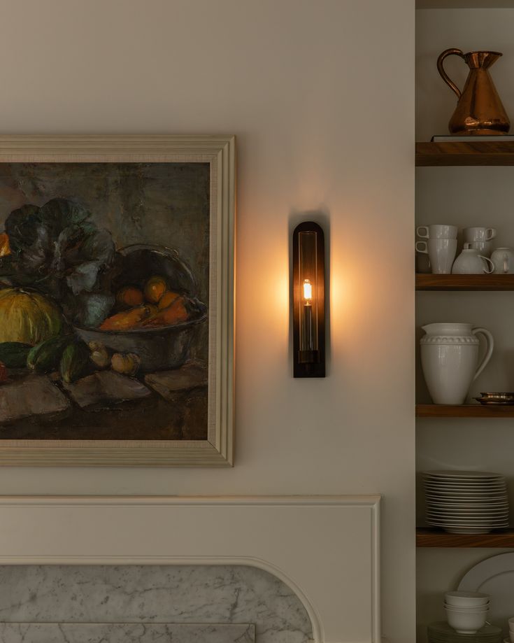 a painting hanging on the wall next to a mantle with plates and bowls in it