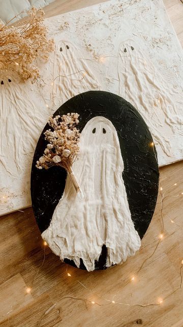 a black and white plate with a ghost decoration on it