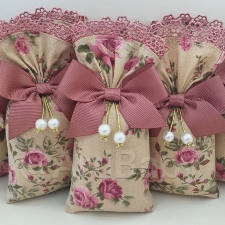 four decorative bags with pink flowers and bows