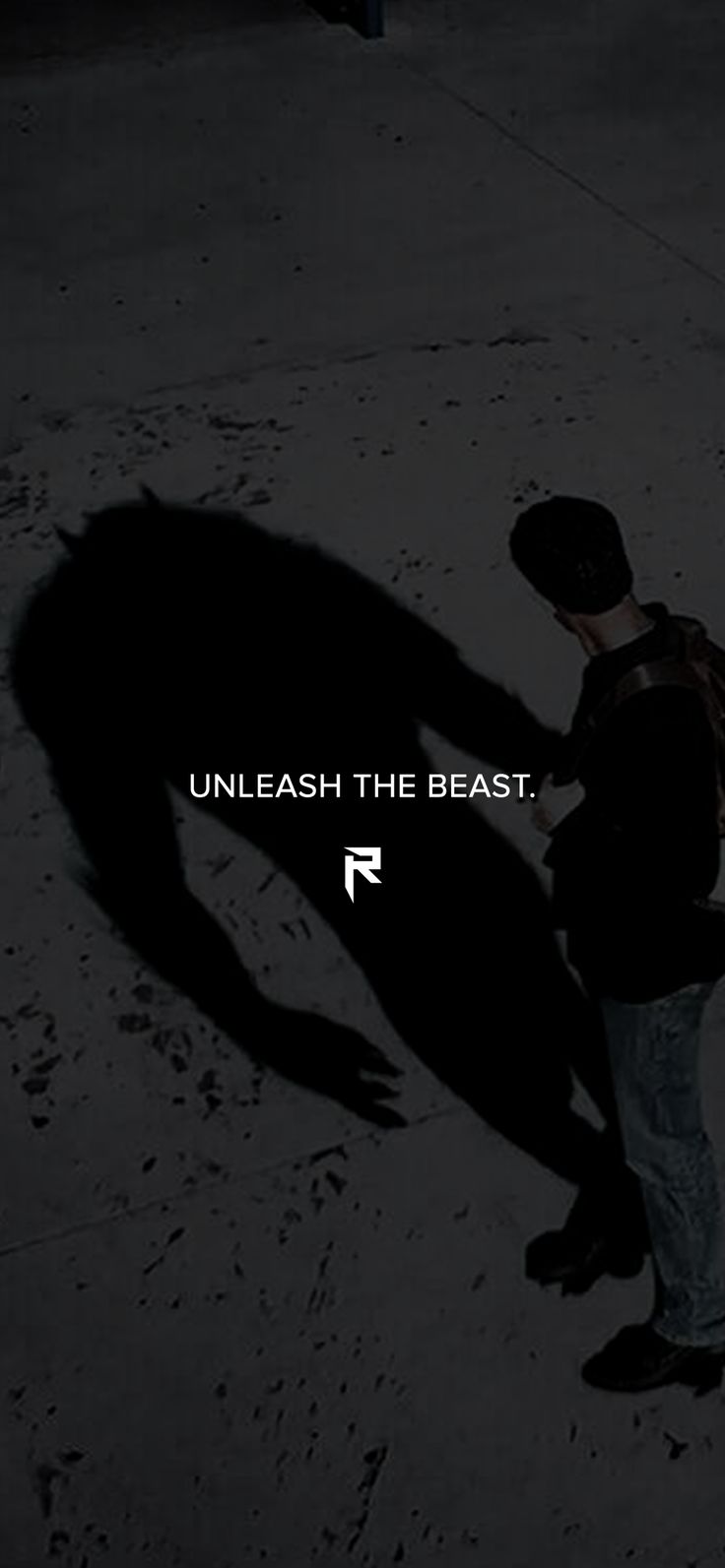 a man standing next to a black and white photo with the words unleash the beast