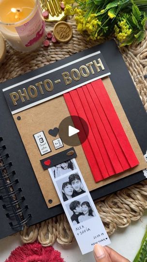 a photo booth is displayed on a table with flowers and other things to do in the background