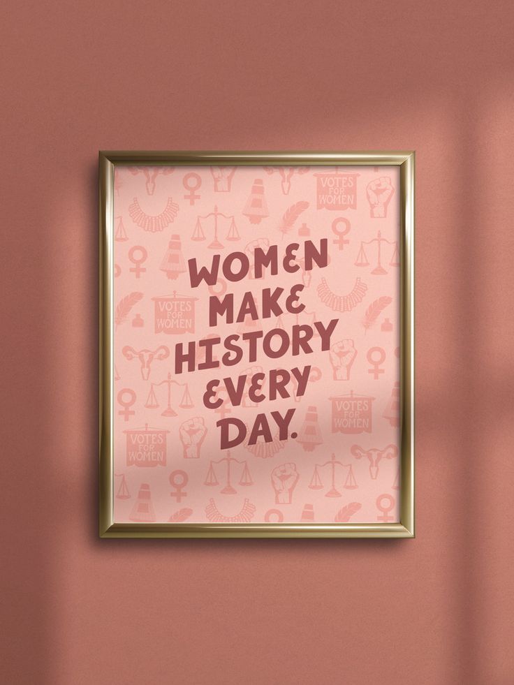 a pink poster with the words women make history every day on it in gold frame