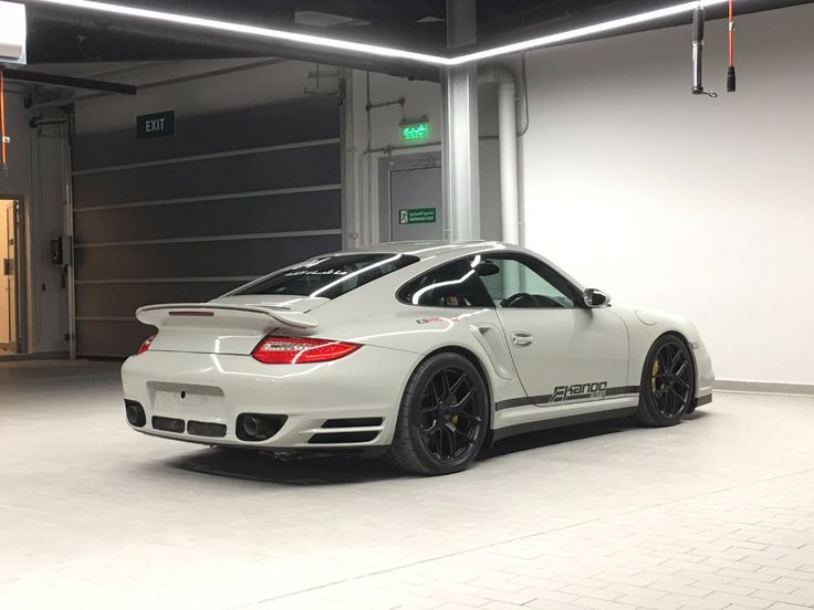 a white sports car parked in a garage